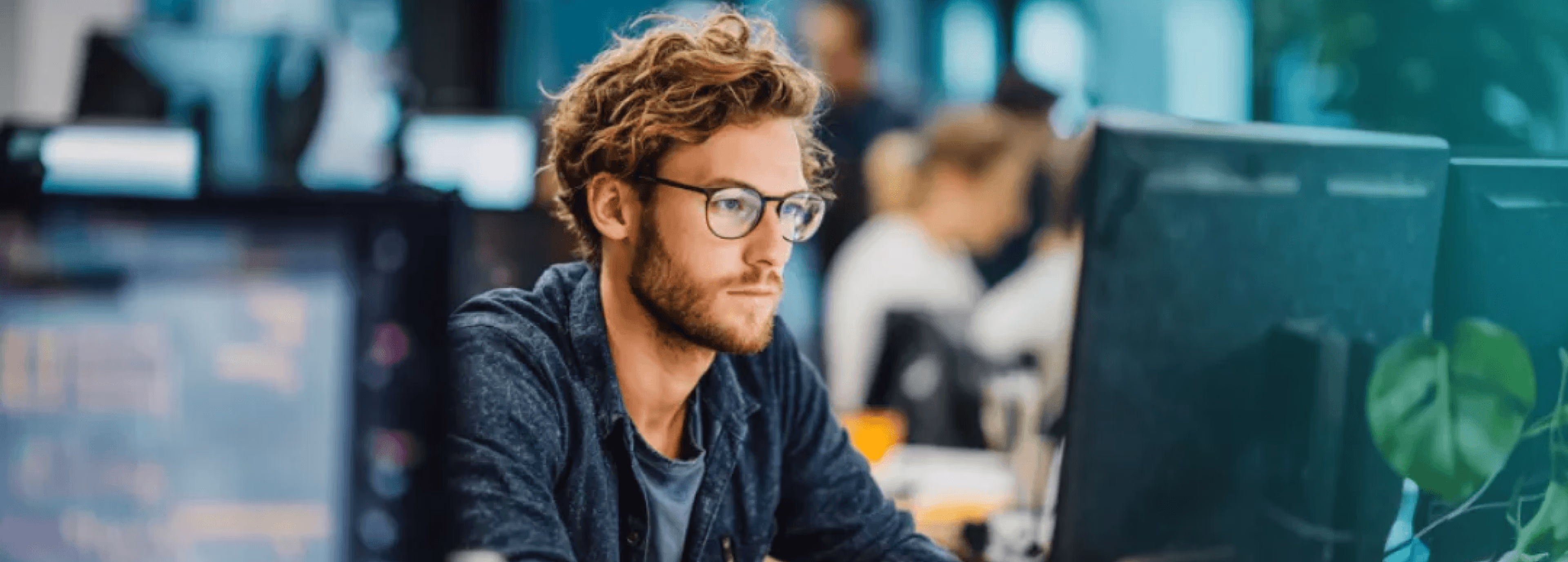 Person working at a computer in a modern open office.