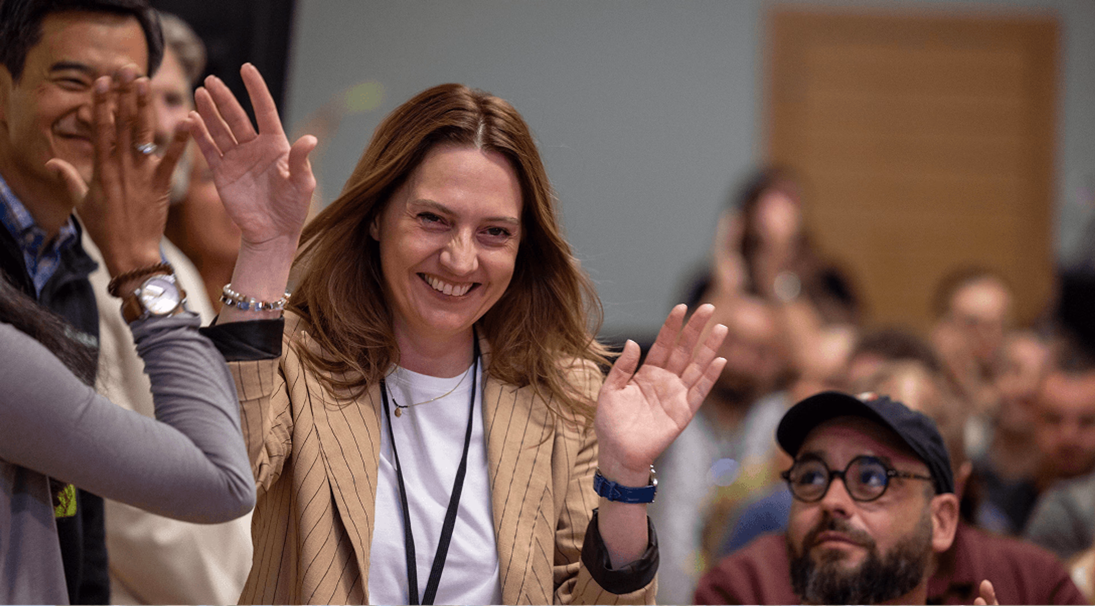 A LucidLink team member giving high-five to others. 