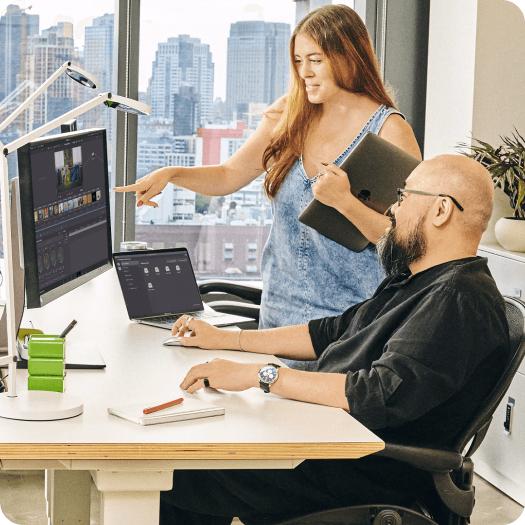 A man and a woman in an office discussing a project in LucidLink.