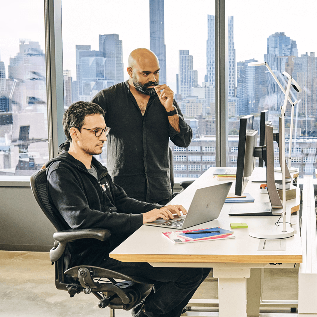 Two man collaborating on a project in the office.