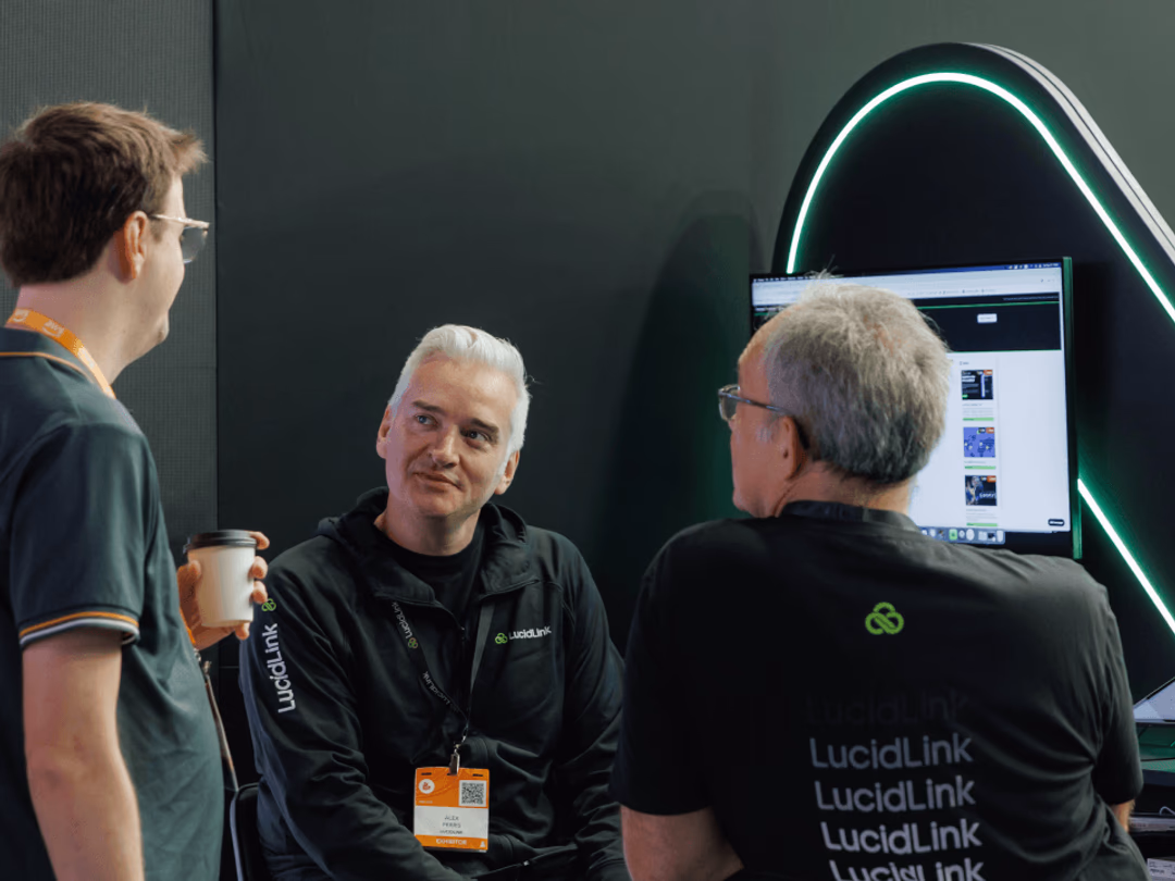 Three LucidLink teammates having a discussion at MPTS. 